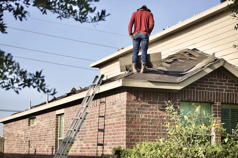 Professional roofer working on a residential roof in Faribault